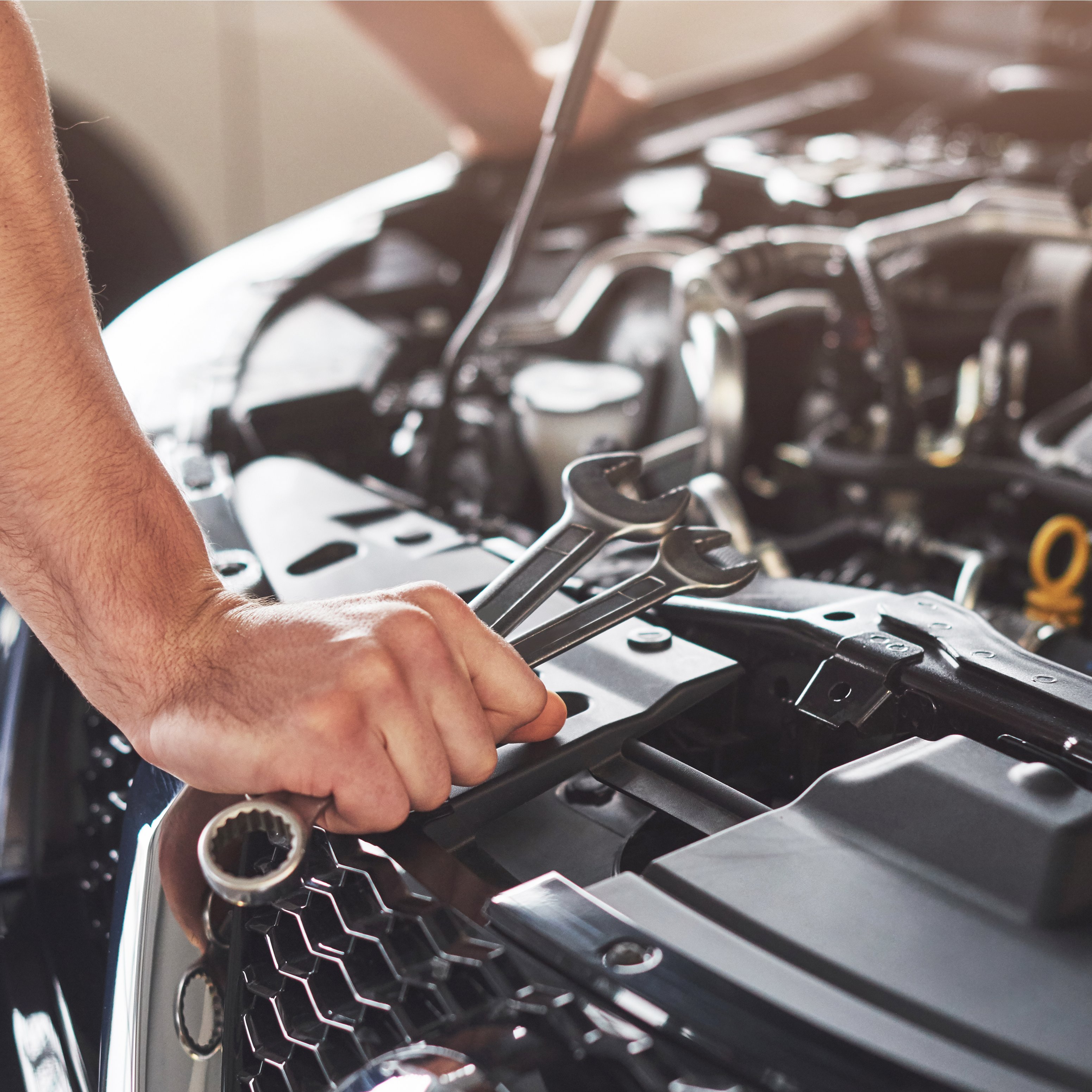 Professional mechanic working on a high-tech car engine